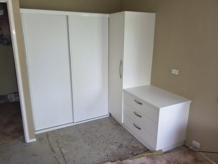 white built in wardrobe and adjoining cupboard